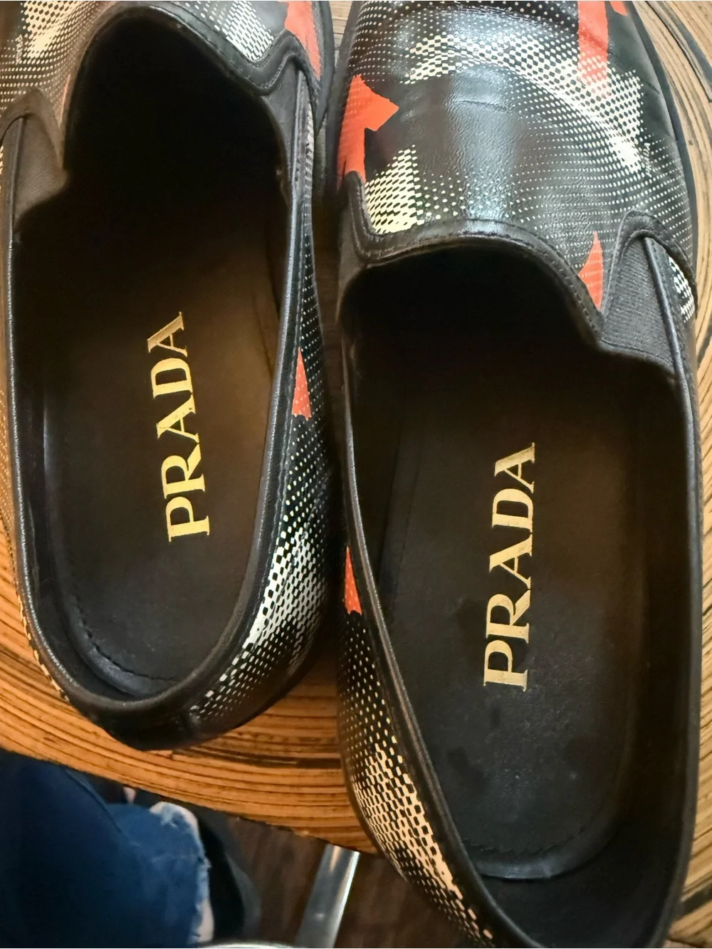 Prada Black Leather Slip-On Loafers with Orange Arrow Motif